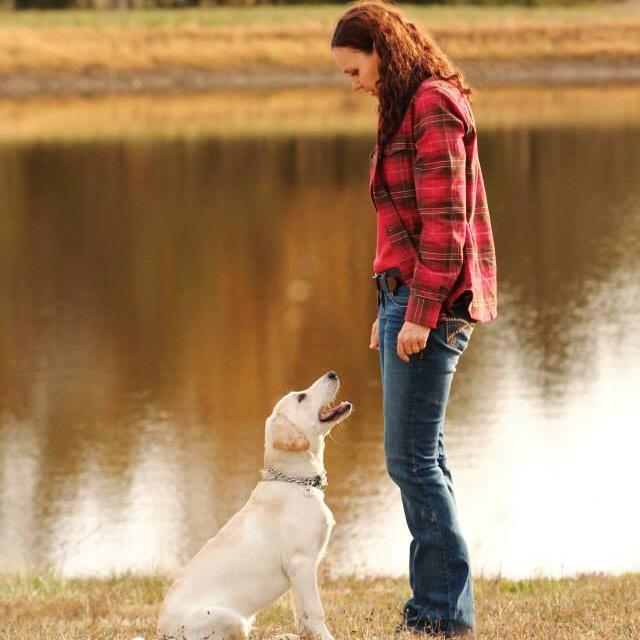 Tango with his trainer beside a lake